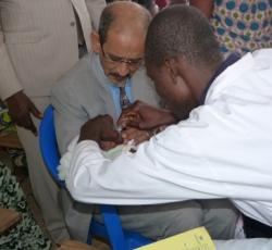 Dr Isselmou Boukhary, représentant de l'Unicef aidant la vaccination d'un enfant