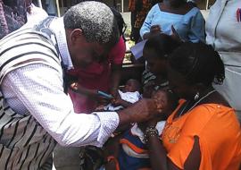 01 The Minister administering first dose of the vaccine