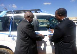 The WHO Representative, Dr. Olusegun Babaniyi right handing over the Toyota Landcruiser Prado to the Vice Chancellor at LAMU, Professor Lupando Munkonge