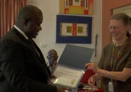 The Assistant Minister receiving the HINARI License Certificate