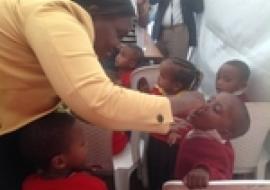 Dr Fiona Braka administering polio drops to a young boy at the NID launching event.