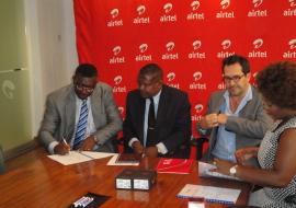 Dr Eugene Nyako, left signing the MOU for the Ebola Virus Disease hotlines