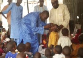 Islamic scholar assisting with Vaccination