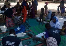 Mobile Hard-to-Reach team providing integrated basic primary healthcare services in a Borno community. M Shafiq/WHO