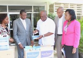 The WHO Representative, Dr. Rufaro Chatora hands over to the Permanent Secretary one of the water treatment tablets