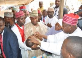 Governor Abdullahi Ganduje of Kano immunizing a child during the June 2015 IPDs