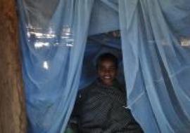 Boy sits under insecticide-treated bed net in Wonchit kebele, Dera Woreda, Amhara Region, Ethiopia.