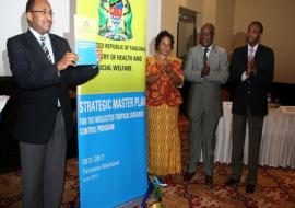 The Minister of Health and Social Welfare, Hon. Dr. Hussein Mwinyi holding the launched national master plan for NTD control and elimination