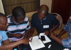 Malaria Case Investigators discussing various scenarios of reading a RDT