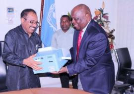 The WHO Representative, Dr. Rufaro Chatora handing over an ELISA Reader to the Minister for Health and Social Welfare, Hon. Dr Seif Rashid.