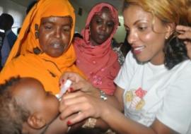 Polio Goodwill Ambassador, e polio goodwill ambassador, Nimco Dareen, administering the two drops.