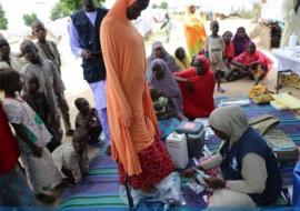 WHO supported Hard to Reach team staff weighs a pregnant woman during one of the outreach in Muna garage IDP camp in Maiduguri, Borno State