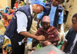 Dr Alemu administering oral polio vaccine to a child in a Borno IDP camp