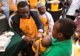 Professor Isaac Florunsho Adewole vaccinating a child to flag-off the 2015 Measles campaign