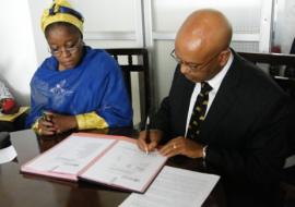 Hon Minister (left) and the WHO Representative signing document