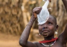 A South Sudanese boy examins a cloth filter The Carter Center