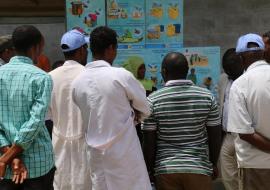 A WHO/UNICEF Risk Communication team member explains AWD prevention and control to health workers and residents of Gabo Gabo Kabele using pictorial posters (Photo: Ms Tseday Zerayaco)