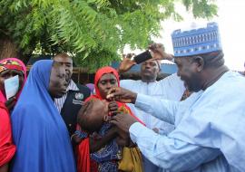 Head of Service,  vaccinating a child with oral cholera vaccine at Muna IDPs camp in Borno state.