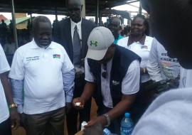 Dr Riek Gai Kok, the Honorable Minister of Health is ready to take Ivermectin tablets administered by WHO NTD Program manager at the Freedom Square Ground in Tonj State. Photo WHO.