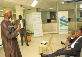 Mr Momodou Gassama (WHO) presenting on stress management in            workplaces for officials of Standard Chartered Bank  Gambia Ltd.