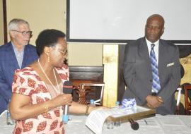 On behalf of the WR, Dr. Ritha Njau handing over the Award to the Chief Medical Officer, Prof. Mohammed Bakari Kambi