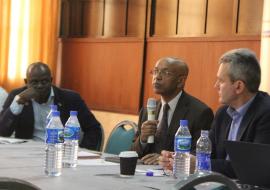 Dr Alemu (with microphone) addressing participants at review of health operations in the northeast Nigeria