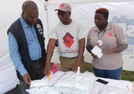 Dr. Lastone Chitembo, HIV/AIDS/TB Advisor at WHO visiting the Society for Family Health exhibition stand where HIV self testing was promoted.