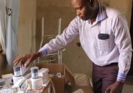 Umar Musami, Psychiatrist, Federal Neuro Psychiatric Hospital looking at medication for mental disorders in Bakass Camp in early March 2018 - Photo: WHO/C. Onuekwe Umar Musami, Psychiatrist, Federal Neuro Psychiatric Hospital looking at medication for mental disorders in Bakass Camp in early March 2018