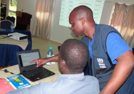 Dr Wamala Joseph helping the participants during the practical session on editing and deleting reports