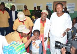 Launching of MCH Week, Minister of Health, Dr Diane Gashumba administering a deworming tablet to a child