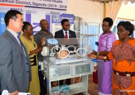 Dr Olive Sentumbwe (right) showing Dr Diana Atwine one of the incubators that were donated. Looking on is Dr Bayo Fatunmbi (red tie), DHOs from Iganga and Kamuli and Mr Kim Sangchul from KOICA