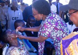 Minister of Health Dr Jane Ruth Aceng vaccinates a member of the community at the launch Minister of Health Dr Jane Ruth Aceng vaccinates a member of the community at the launch