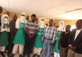 The Hon. Minister of Health, Dr. Chitalu Chilufya, (Centre) with the WHO Representative, Dr. Nathan Bakyaita (far left) with one of the RRTs in Solwezi