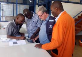 WHO and MoH staff checking on the Ebola Cold Chain Freezers that were delivered