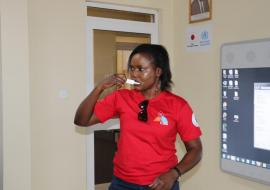 Ms Betty Araba of UNAIDS swabbing her mouth for an oral fluid sample for self-testing