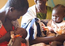 With Bakhita on her lap, Tereza encourages Ajonga to breastfeed her granddaughter, baby Akot. With Bakhita on her lap, Tereza encourages Ajonga to breastfeed her granddaughter, baby Akot.
