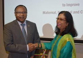 Dr Laurent Musango, WHO Representative in Mauritius receiving a copy of the National Roadmap Framework To improve Maternal, Newborn and Child Health from Mrs. Shabina Lotun, Permanent Secretary of the Ministry of Health and Wellness