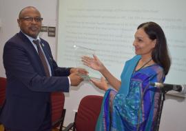 Dr L.  Musango, WHO Representative in Mauritius receiving a shield from Mrs S. Nirsimloo-Gayan, Director General of the Mahatma Gandhi Institute, Moka, Mauritius