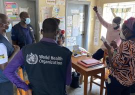 WHO officials talk to the health workers at Kasensero Health Center II