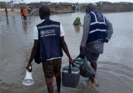 Health Workers wading through tough terrains.jpg