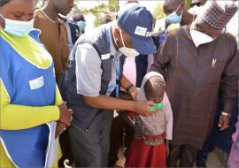 WHO Country Rep. Dr Mulombo administers anti-malaria drug to an eligible child at Elmiskin IDPs camp in Maiduguri, Borno state during the flag-off of 4th Cycle of SMC_Photo_WHO_CEOnuekwe.jpg