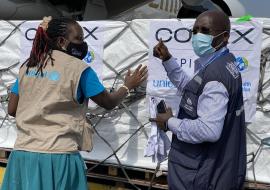   A UNICEF and WHO official receiving the initial batch of COVID-19 vaccines at Entebbe International Airport in Uganda A UNICEF and WHO official receiving the initial batch of COVID-19 vaccines at Entebbe International Airport in Uganda