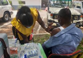 Health worker vaccinating a client in the Kumasi in the Ashanti Region of Ghana