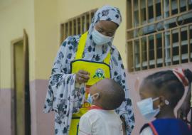 Vaccinator administering drops of nOPV to eligible child within COVID-19 context.jpg