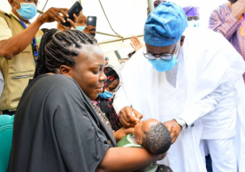 Osun State Governor Oyetola vaccinating a child at the flag-off nOPV vaccination campaign in the state.