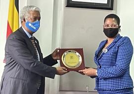 The WHO Representative, Dr. Yonas Tegegn Woldemariam receives a plaque from The Deputy Speaker of Parliament, Rt.Hon. Anita Among in recognition WHO's support to the Government of Uganda in Health