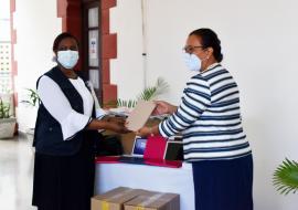 The Minister of Health Honourable Peggy Vidot accepting the donations of tablet from the WRai Dr. Susan Tembo.