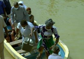 Health workers returning from a riverine settlement.