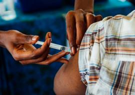 A healthcare provider giving COVID-19 vaccine in Manyara