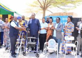 Dr. Yoti handing over assistive products to the Guest of Honor